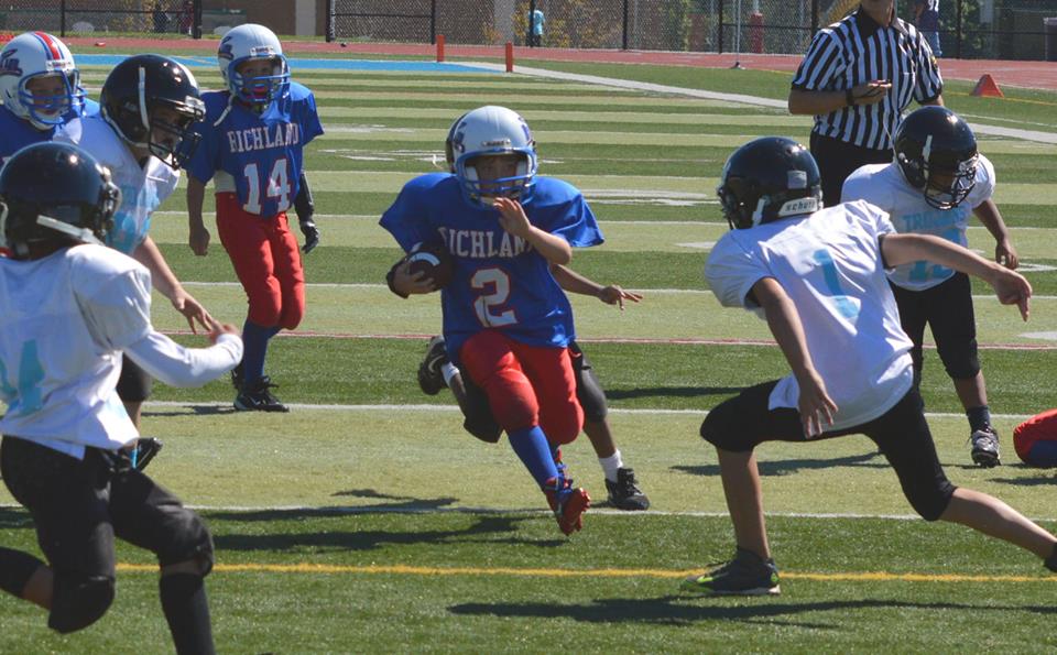 A photo of the Laurel Highlands Developmental Football League playing tackle football on the field